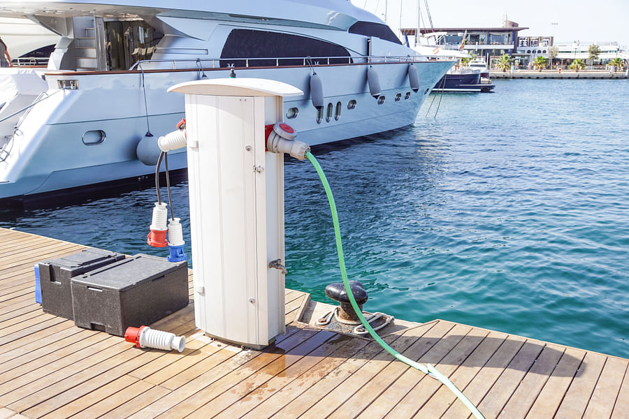 Variety of marine batteries lined up on a boat dock