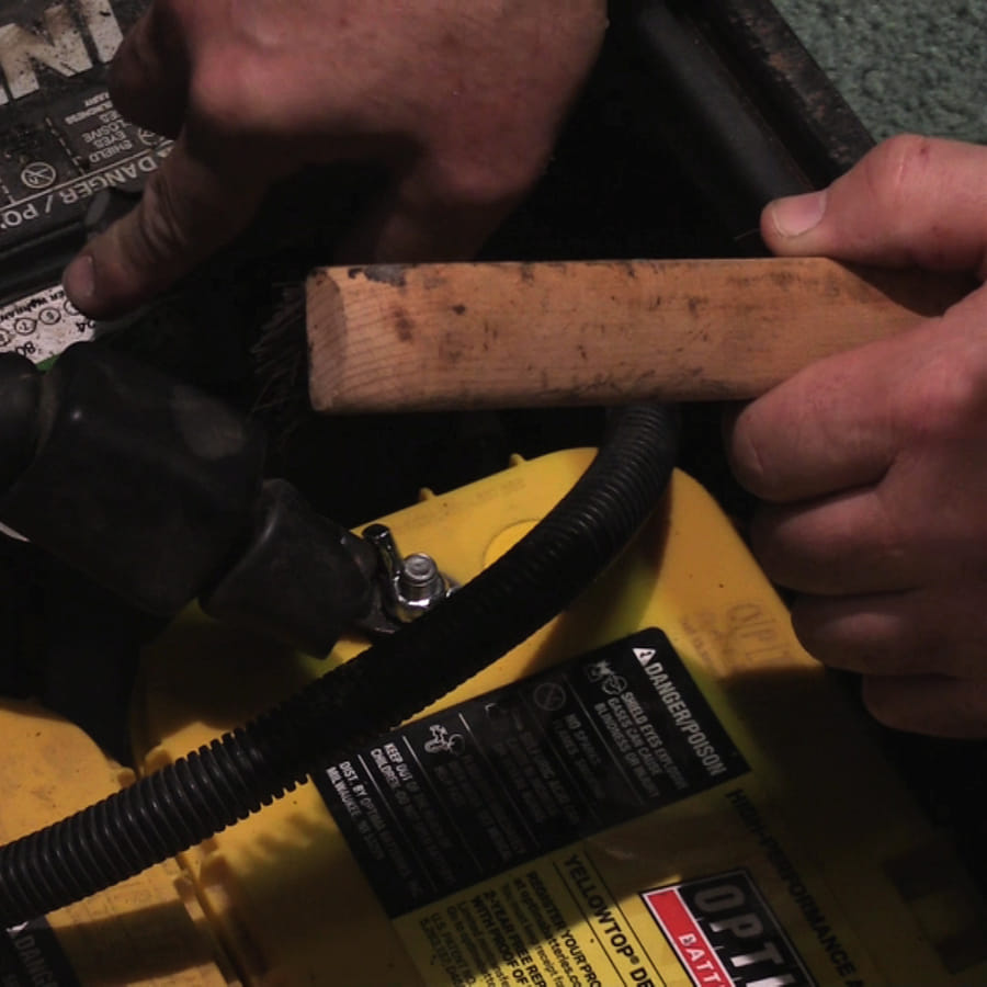 Person performing maintenance on an RV battery